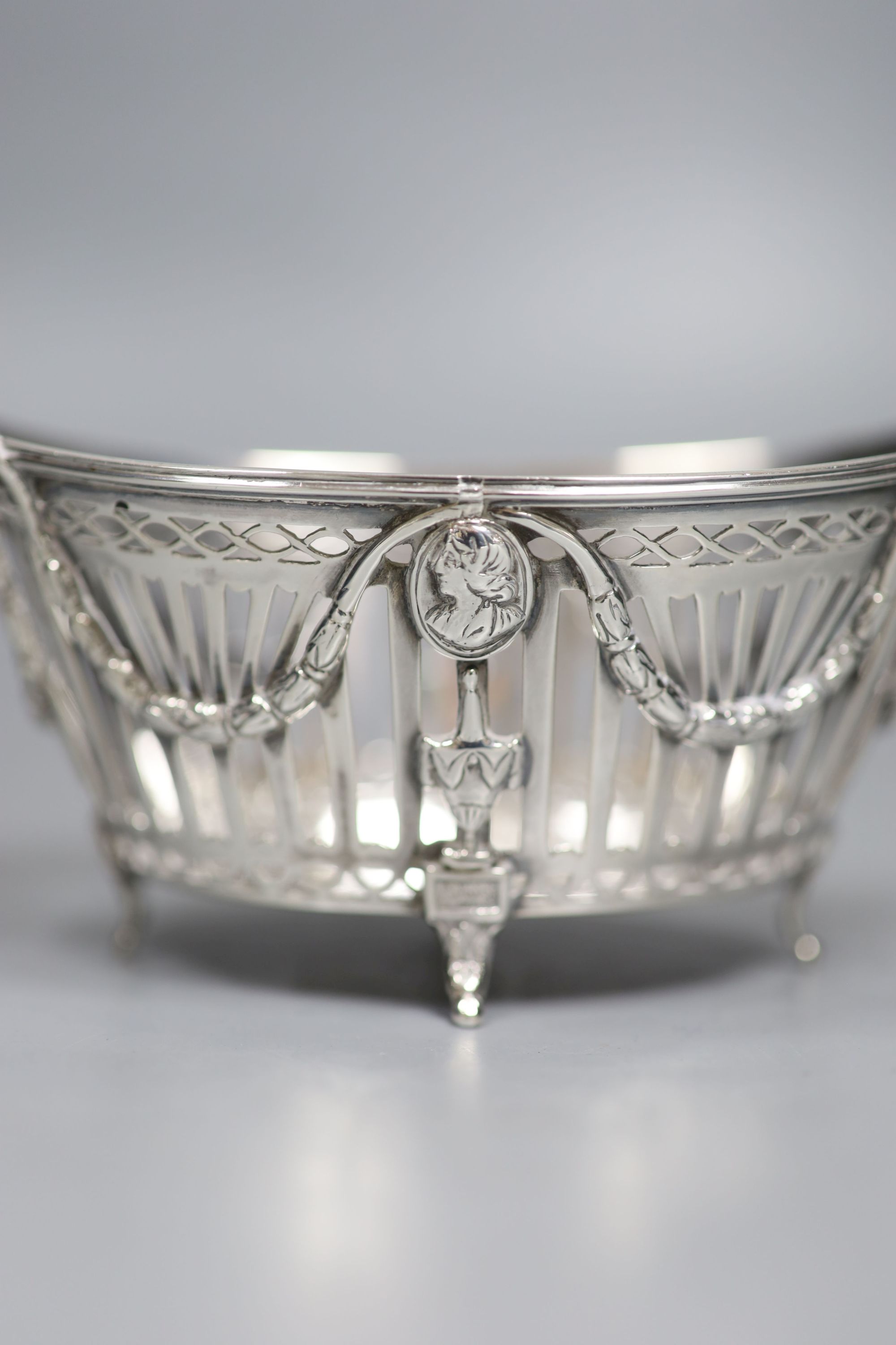 A late 19th/early 20th century Dutch pierced white metal ring handled navette shaped basket